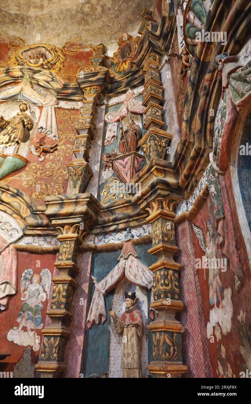 Detail of ornate carved and painted embellishments inside San Xavier