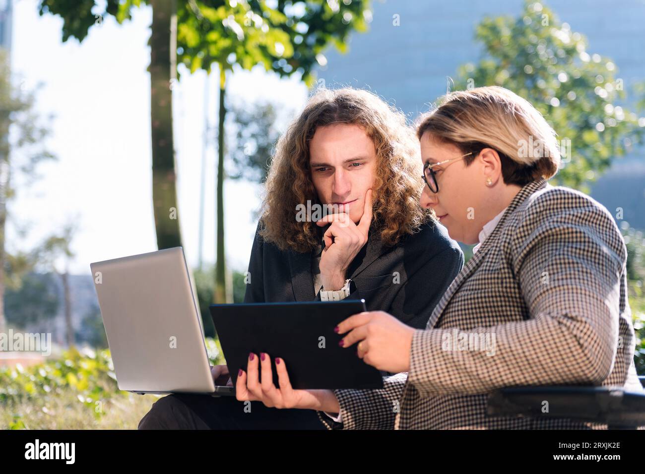 businessman and businesswoman working outdoors Stock Photo