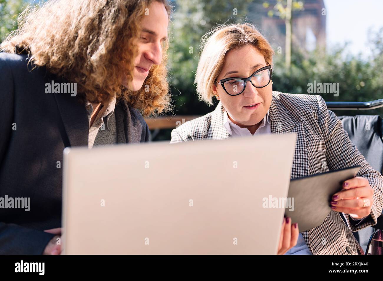 businessman and businesswoman working outdoors Stock Photo