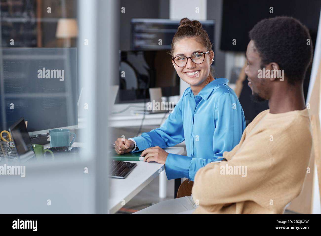 Couple of young programmers working with software on computer in team in IT office Stock Photo