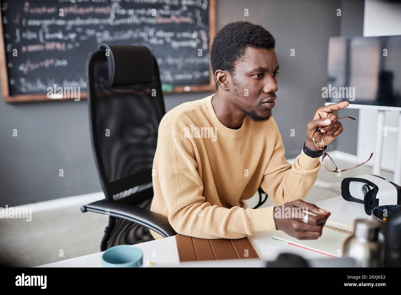 African American programmer working on computer at his workplace in IT office Stock Photo
