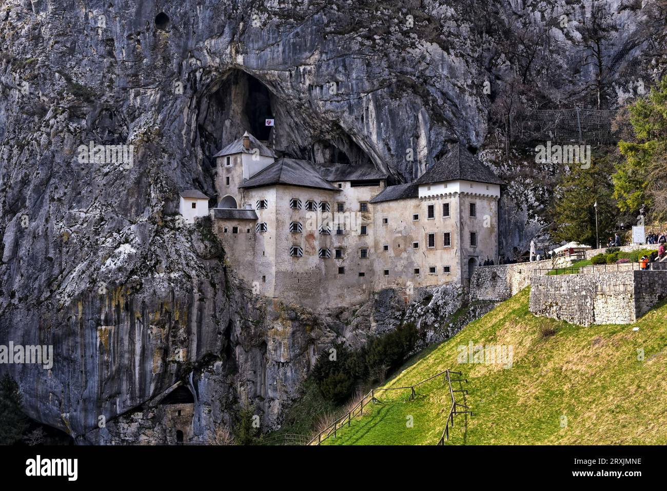 Predjama Castle, a 13th-century castle built in cliff face cave with dungeons and secret tunnels. Predjama, Slovenia Stock Photo