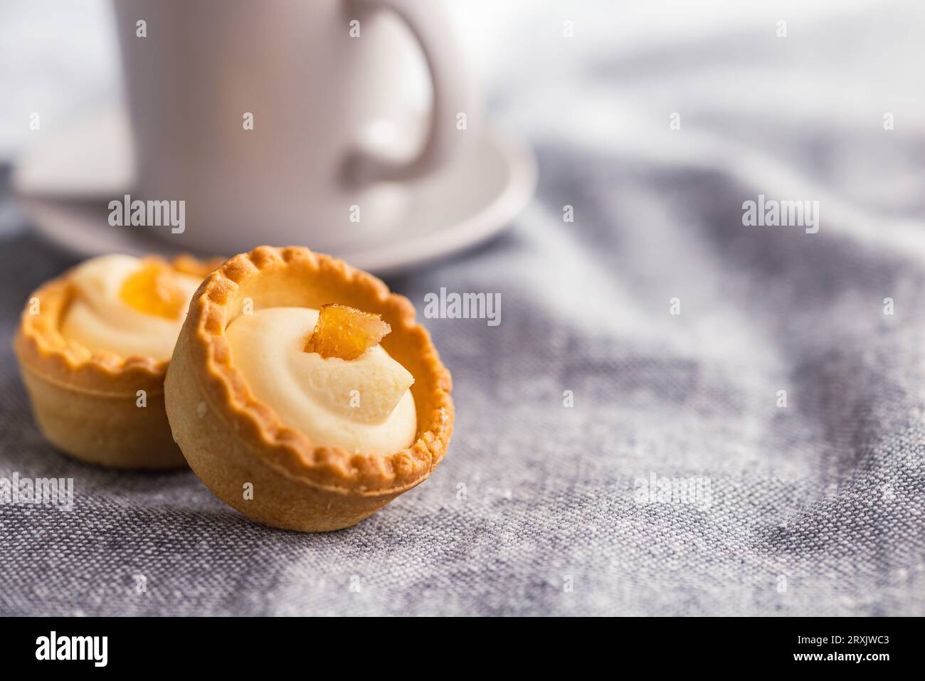 Sweet tarlets. Tasty mini tarts. Mini pie with cream on the kitchen ...