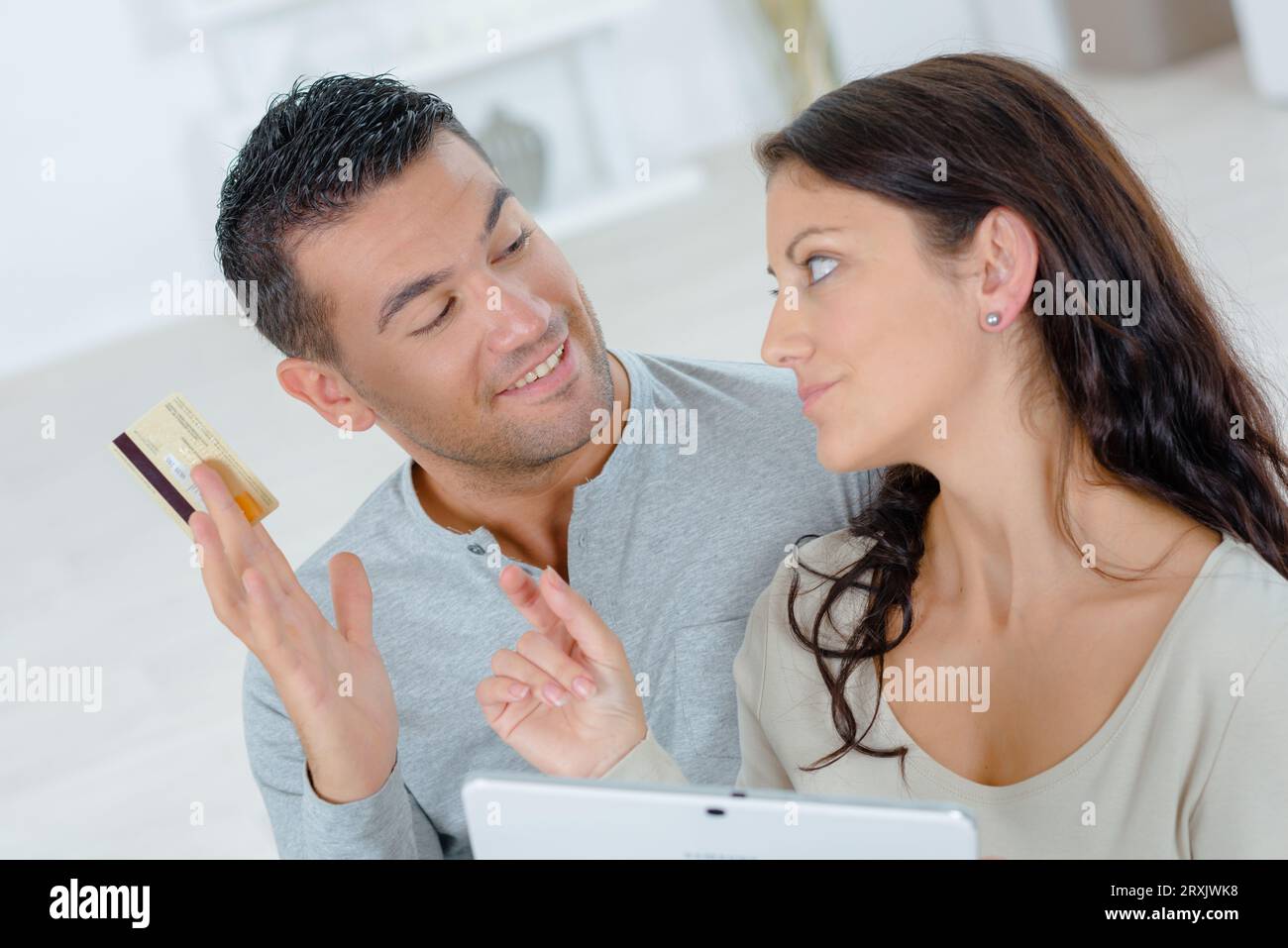 man is teasing his girlfriend shopaholic Stock Photo