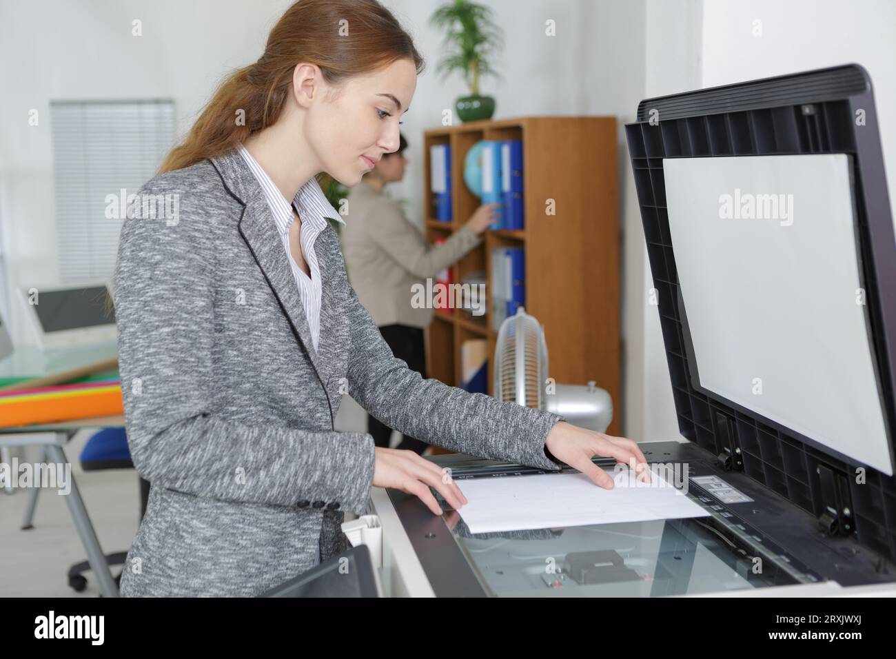 teacher is printing off work sheets for her next lesson Stock Photo