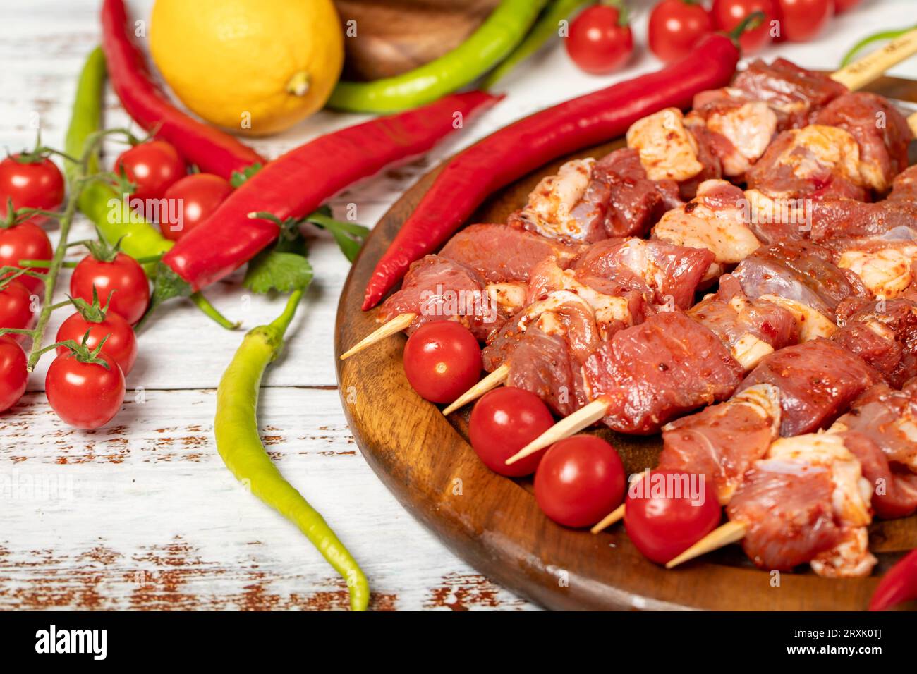 Lamb skewers on wood background. Raw lamb skewer with herbs and spices. Local name kuzu kusleme. Copy space. Free space for text Stock Photo