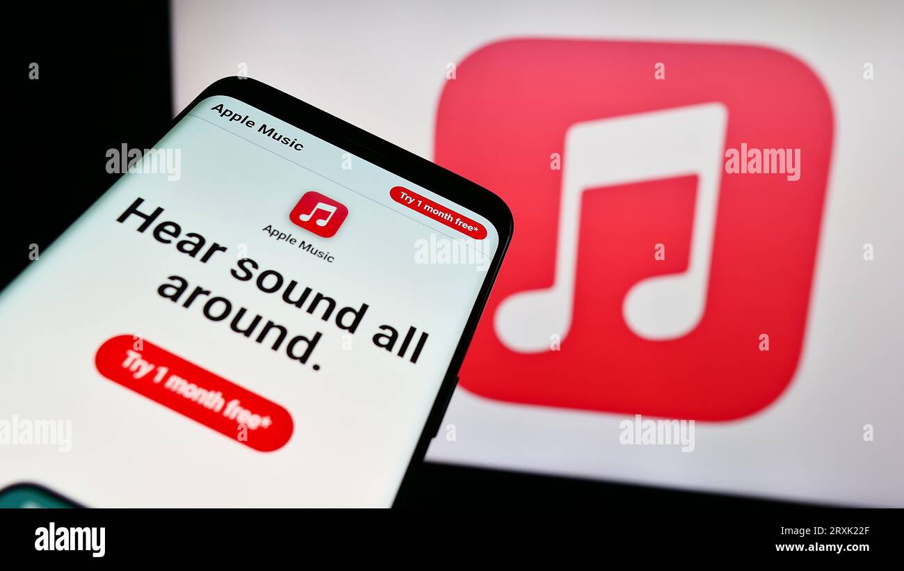 Smartphone with website of streaming service platform Apple Music on screen in front of business logo. Focus on top-left of phone display. Stock Photo