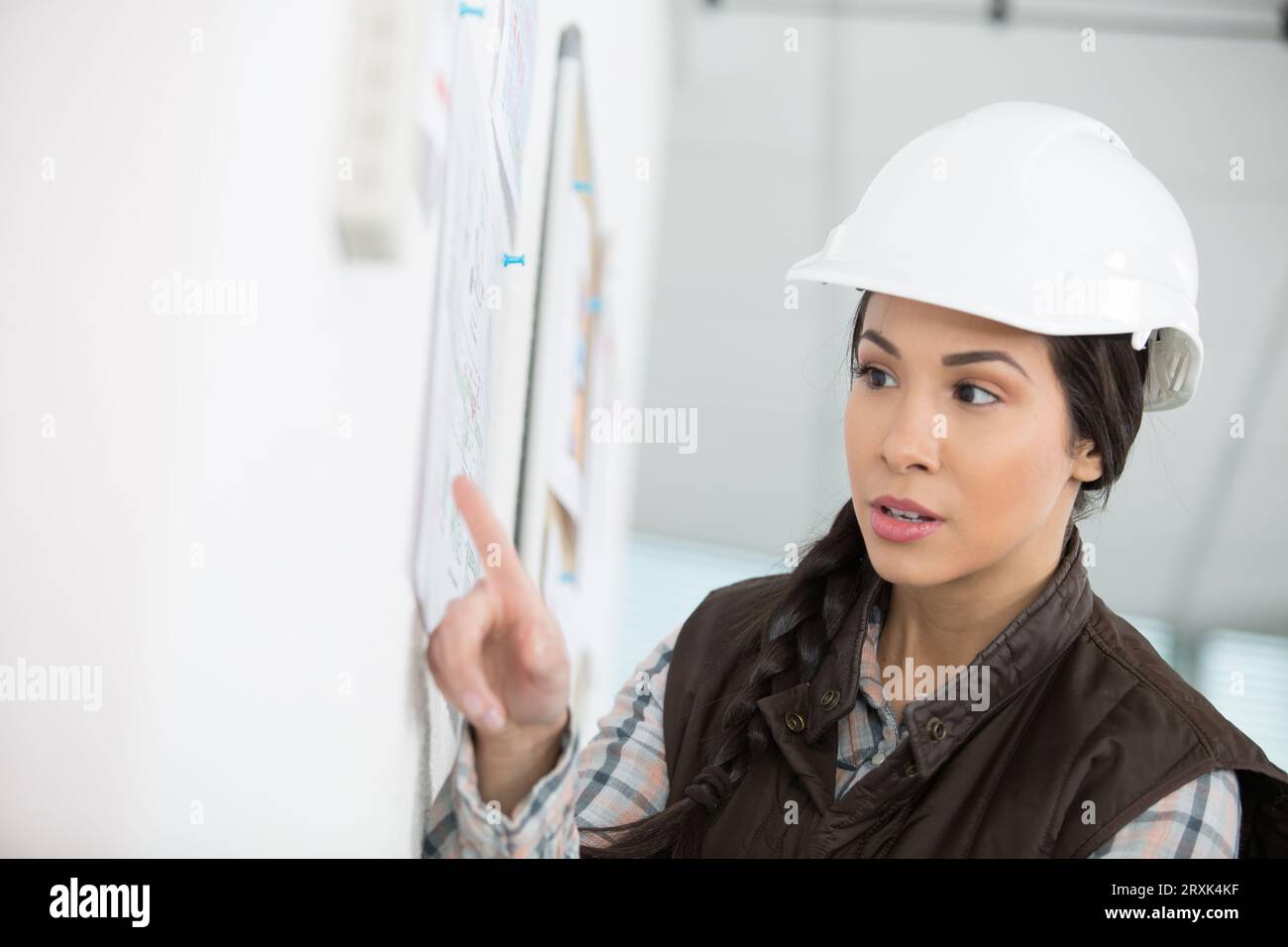 a female builder is checking the planning Stock Photo