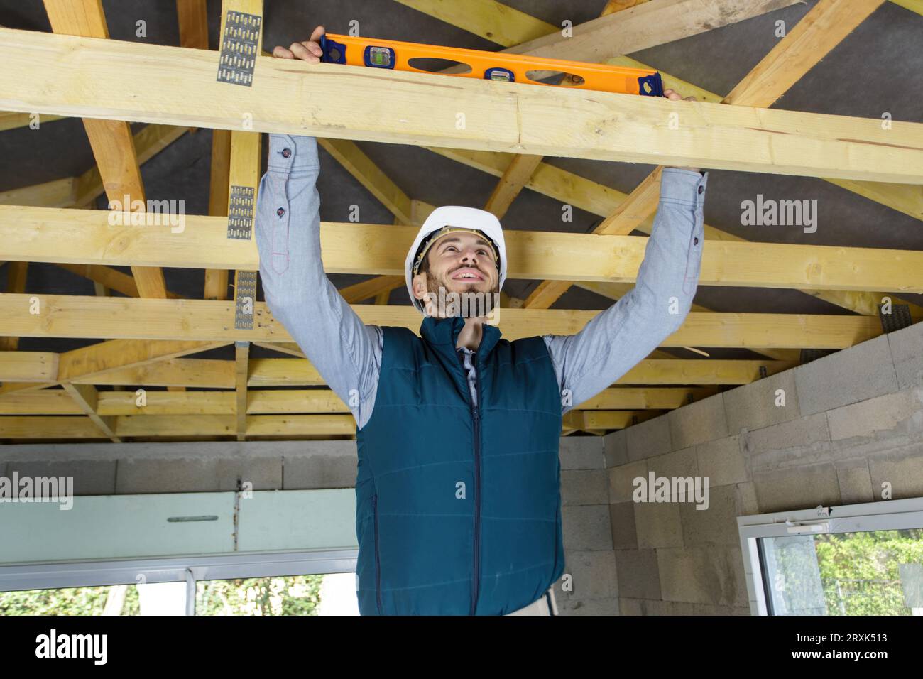 carpenter using a spirit level on wood Stock Photo