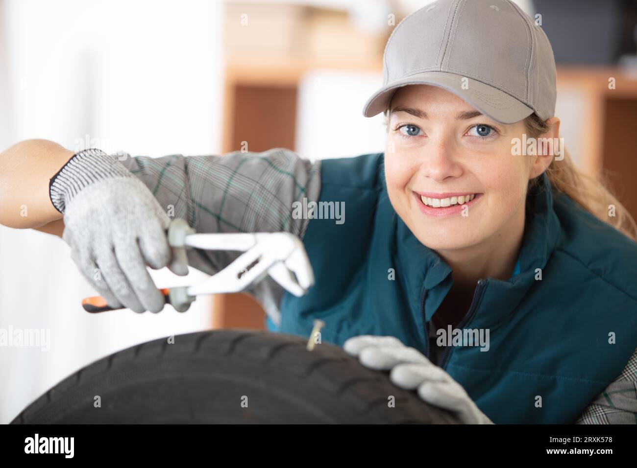 female auto repair mechanic repairing tyre Stock Photo Alamy