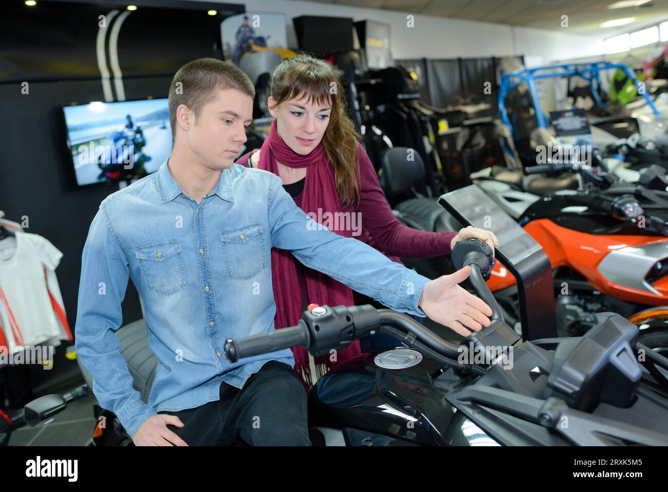 beautiful young couple in the showroom choosing a car Stock Photo