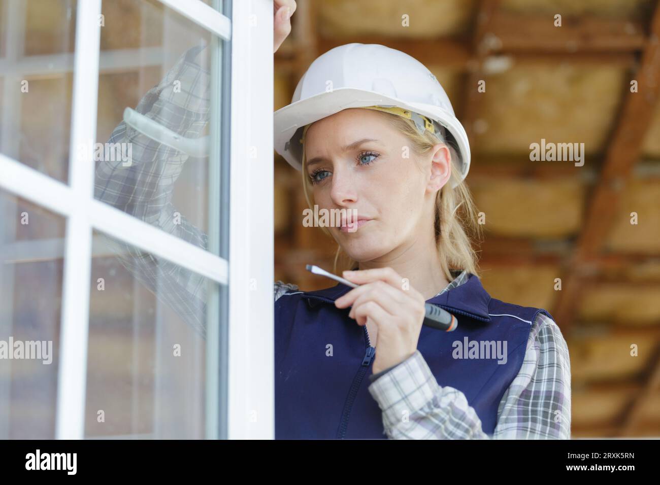 worker hands installing mosquito net Stock Photo