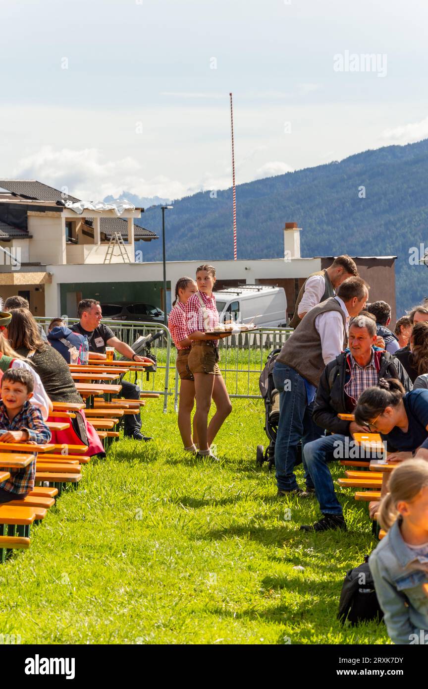 Tyrolean waitresses serve food Stock Photo