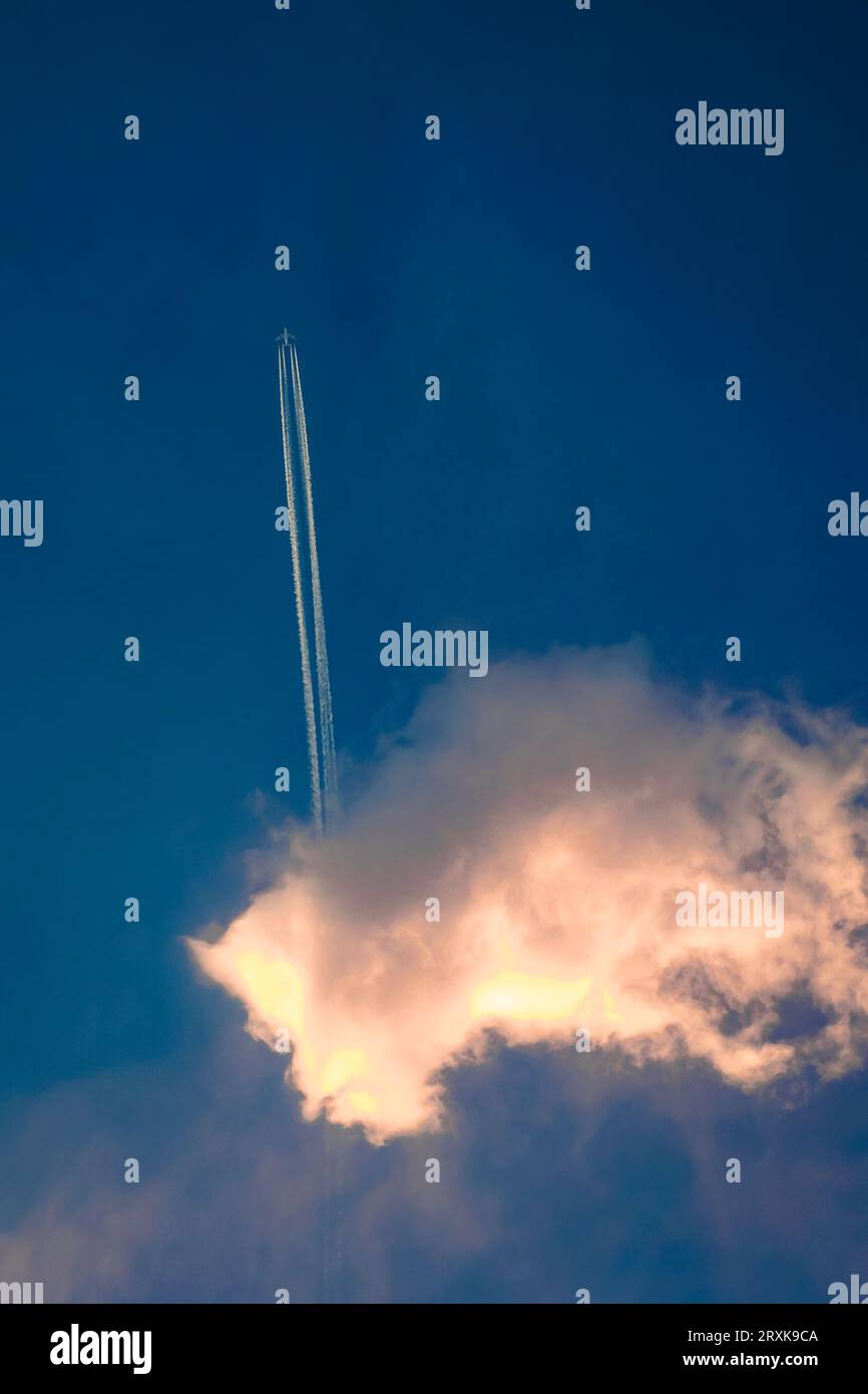 Blue jet plane in cloudy hi-res stock photography and images - Alamy