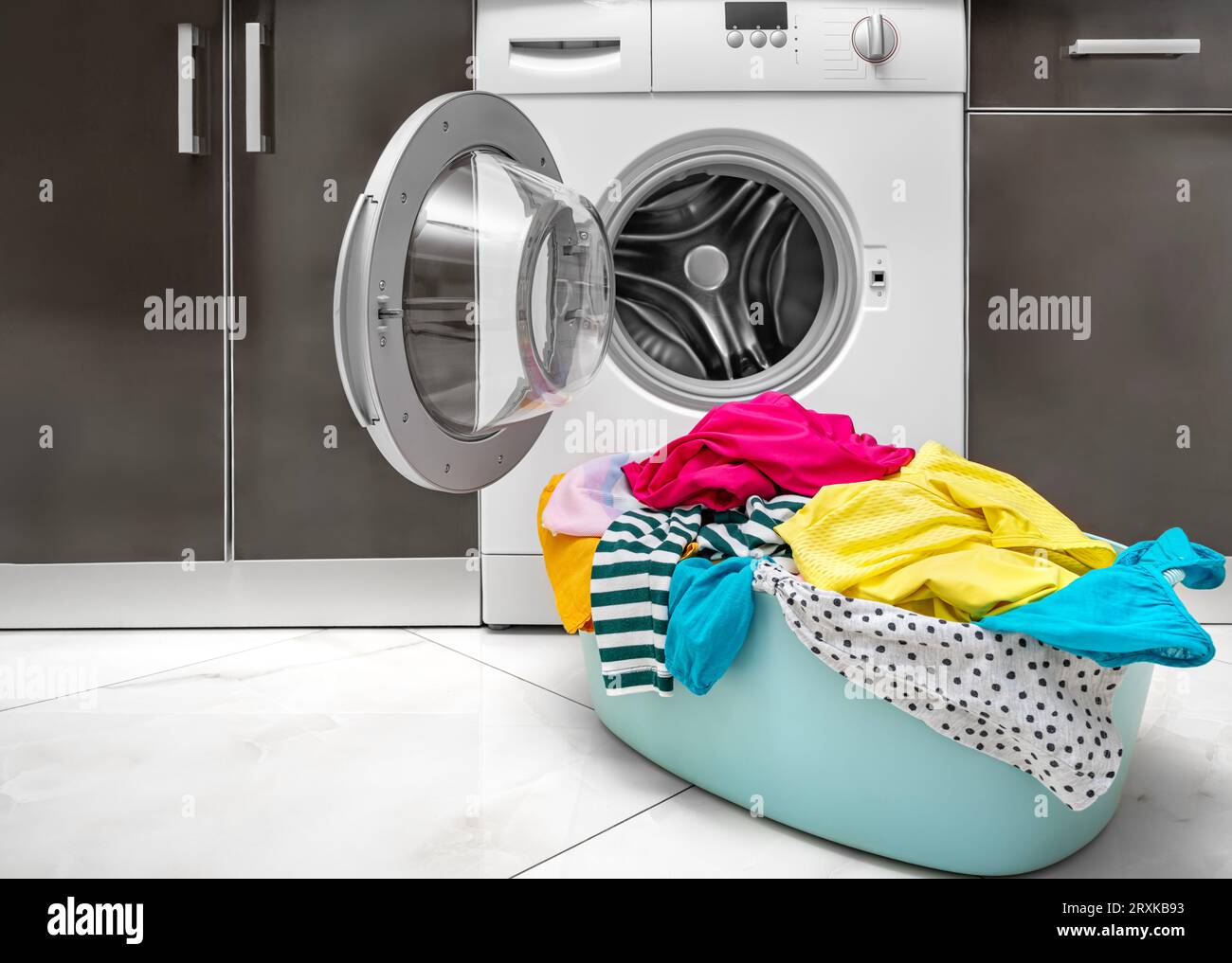 Multi-colored linen for washing in the washing machine. Stock Photo