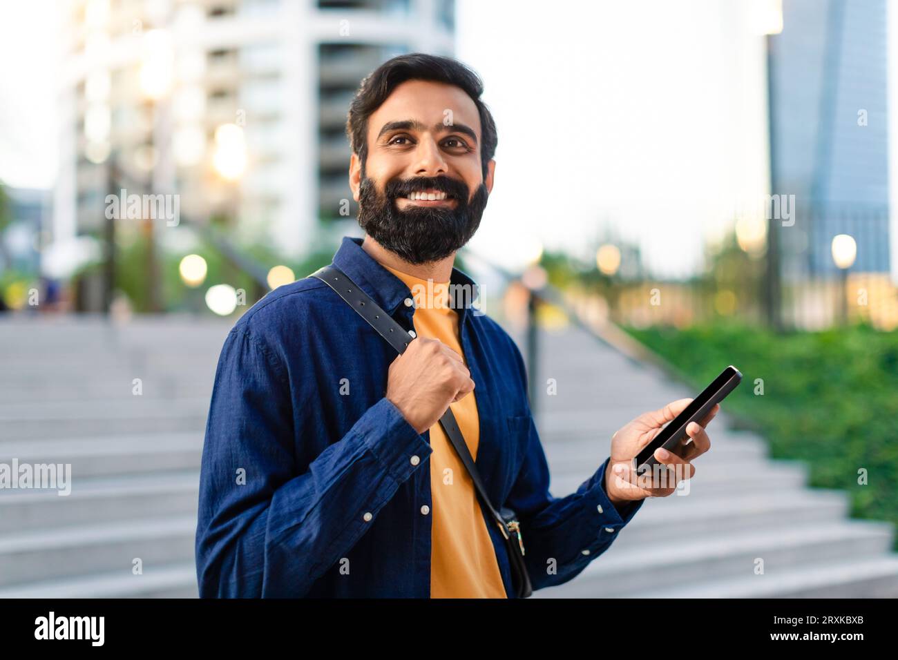Indian businessman holds smartphone hi-res stock photography and images ...