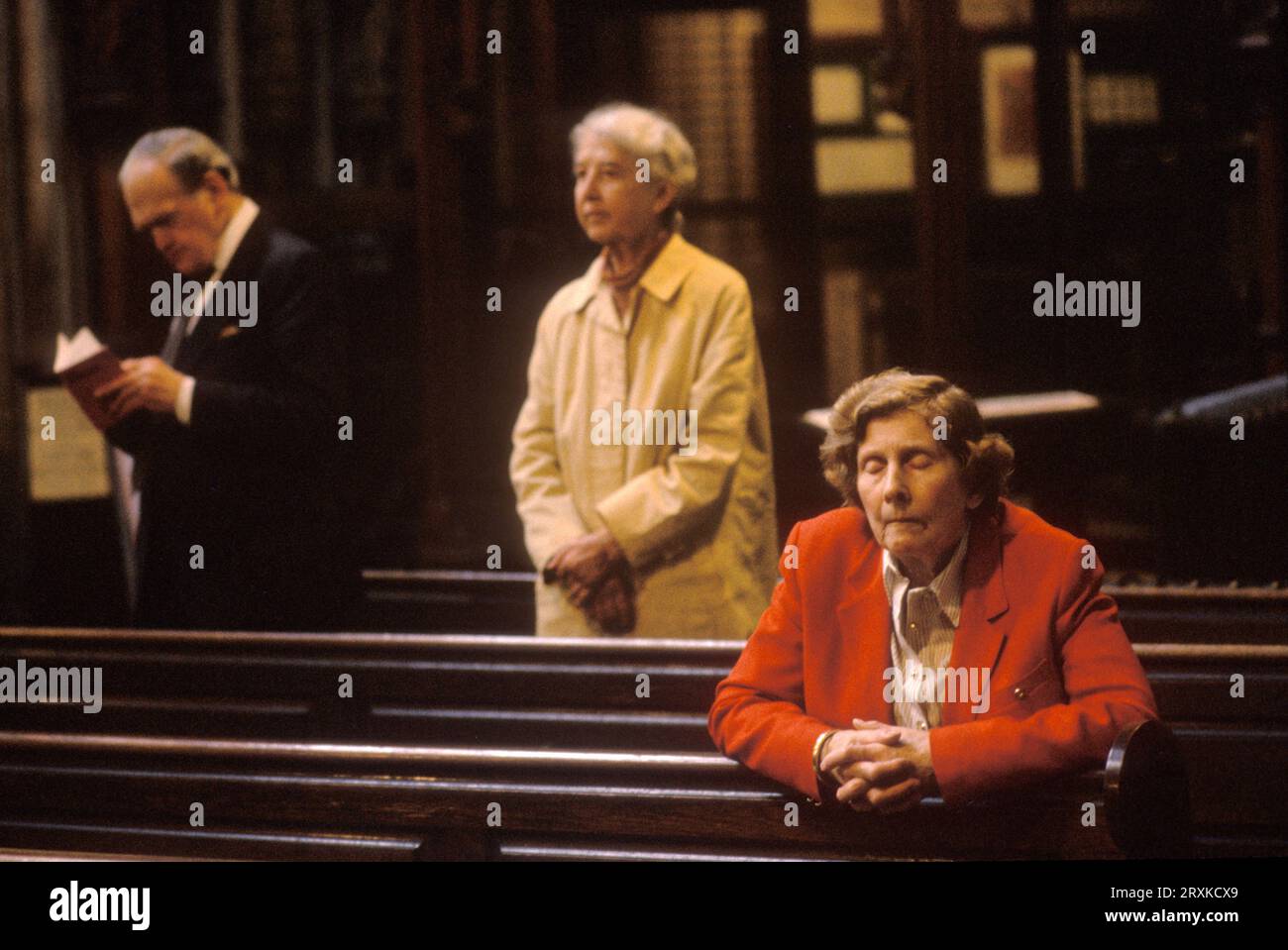 Praying in church an older woman deep in religious contemplation. The