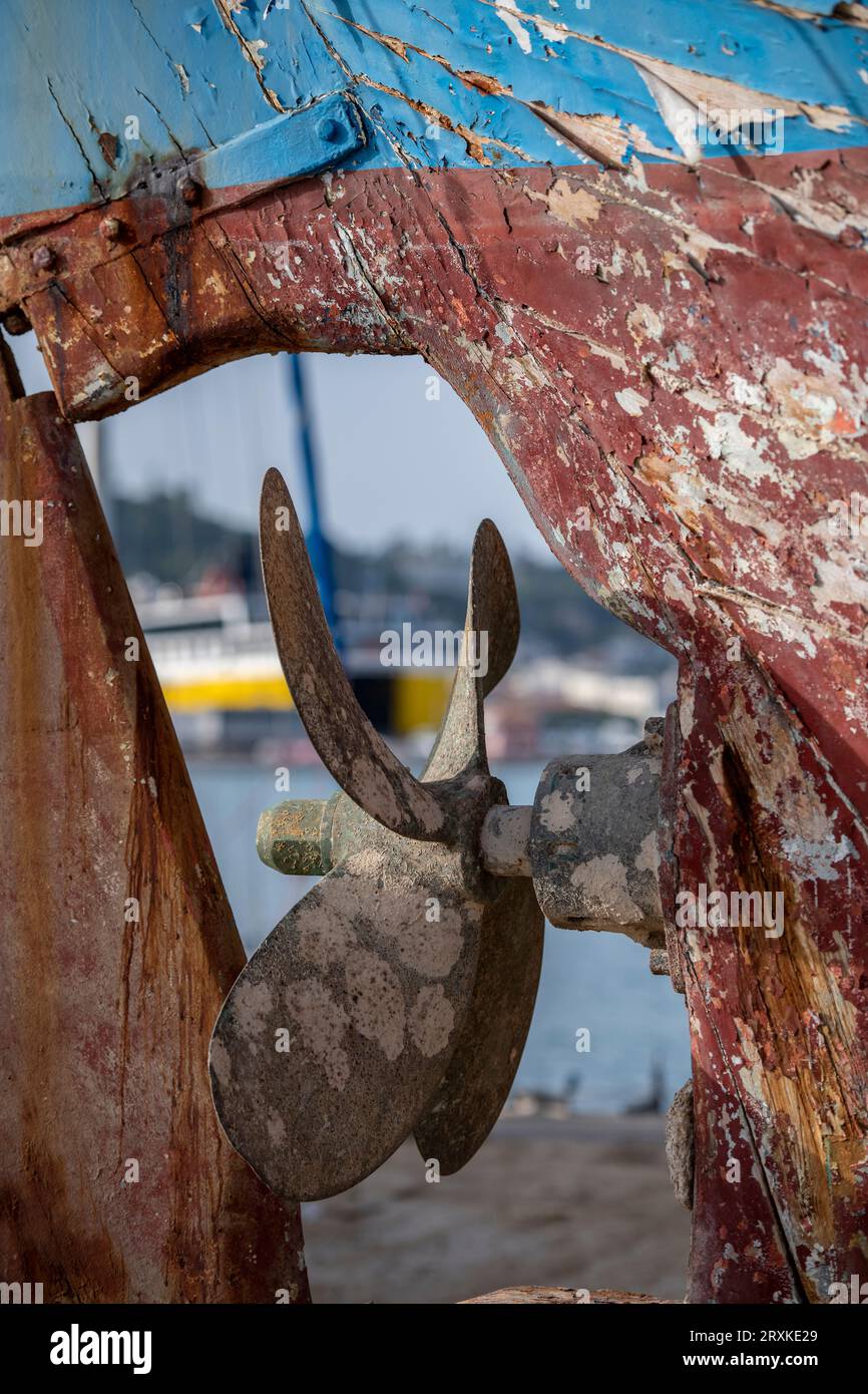 old brass or bronze propellor and rudder on an old wooden traditional ...