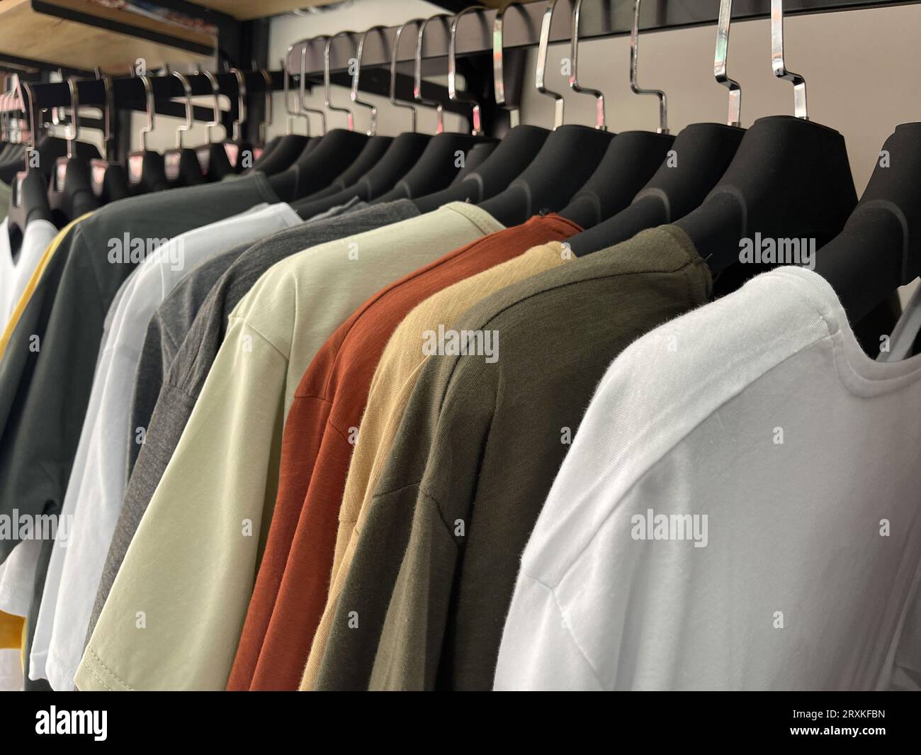 T-shirt hanging on hangers in the clothing store Stock Photo