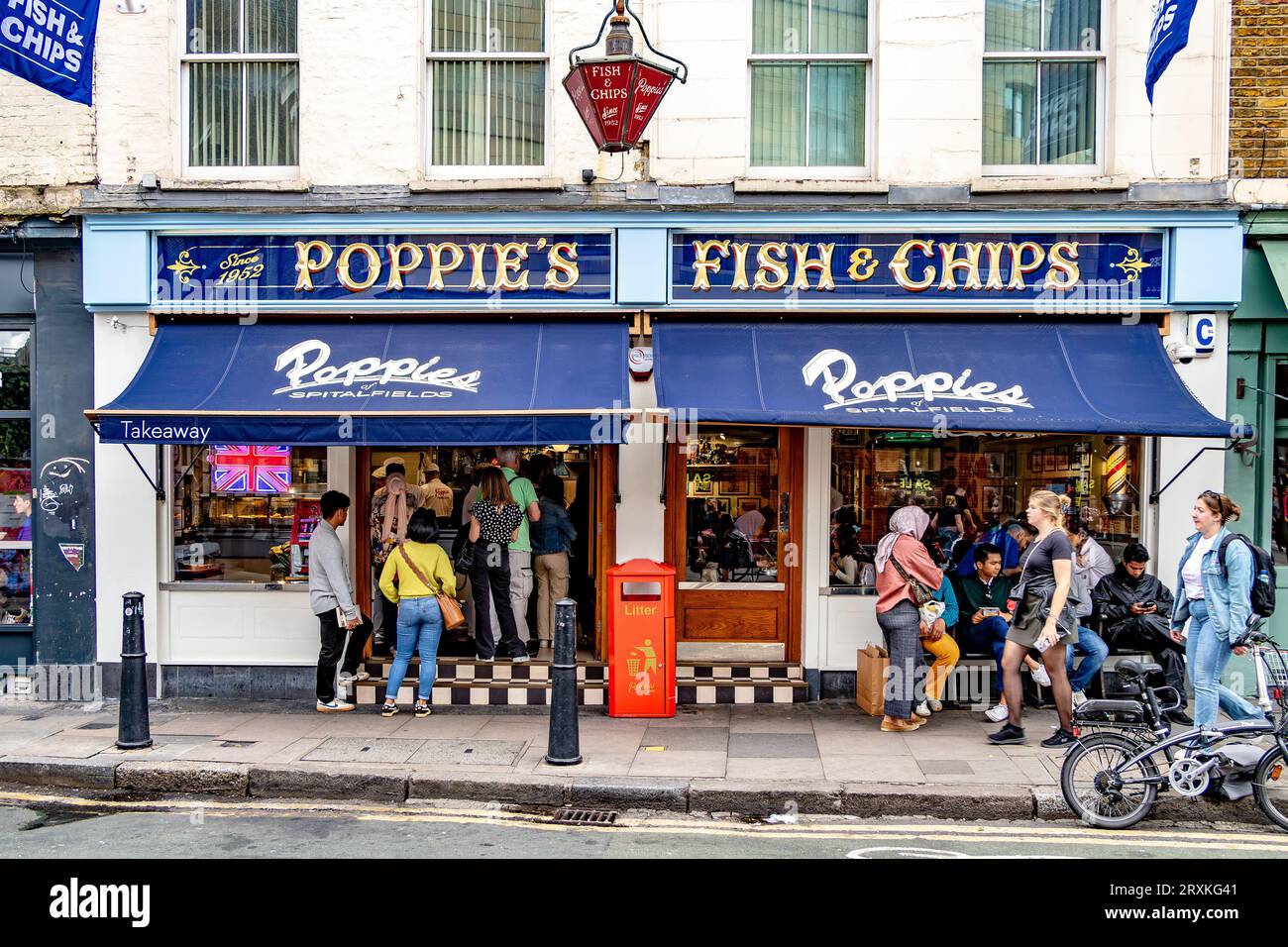 People buying fish and chips at Poppies Fish & Chip shop Spitalfields,London E1 Stock Photo