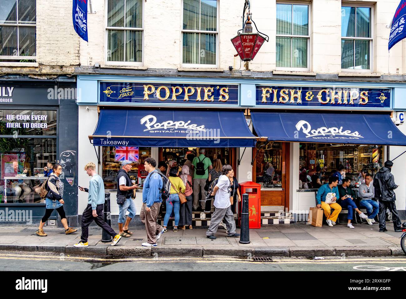 People buying fish and chips at Poppies Fish & Chip shop Spitalfields,London E1 Stock Photo