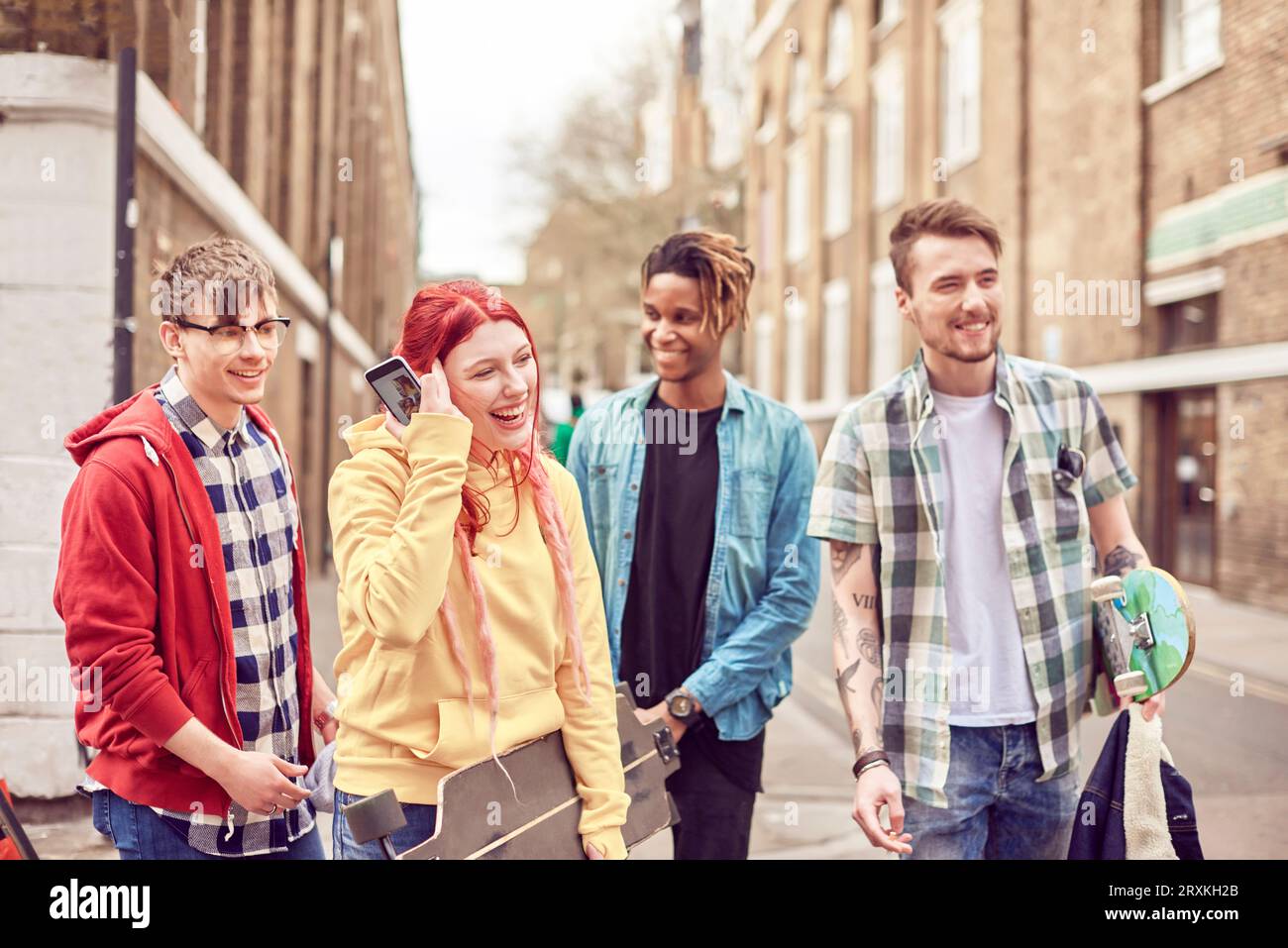 Teenage friends standing in street Stock Photo