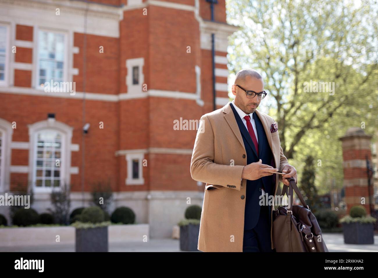 Businessman text messaging on smart phone Stock Photo