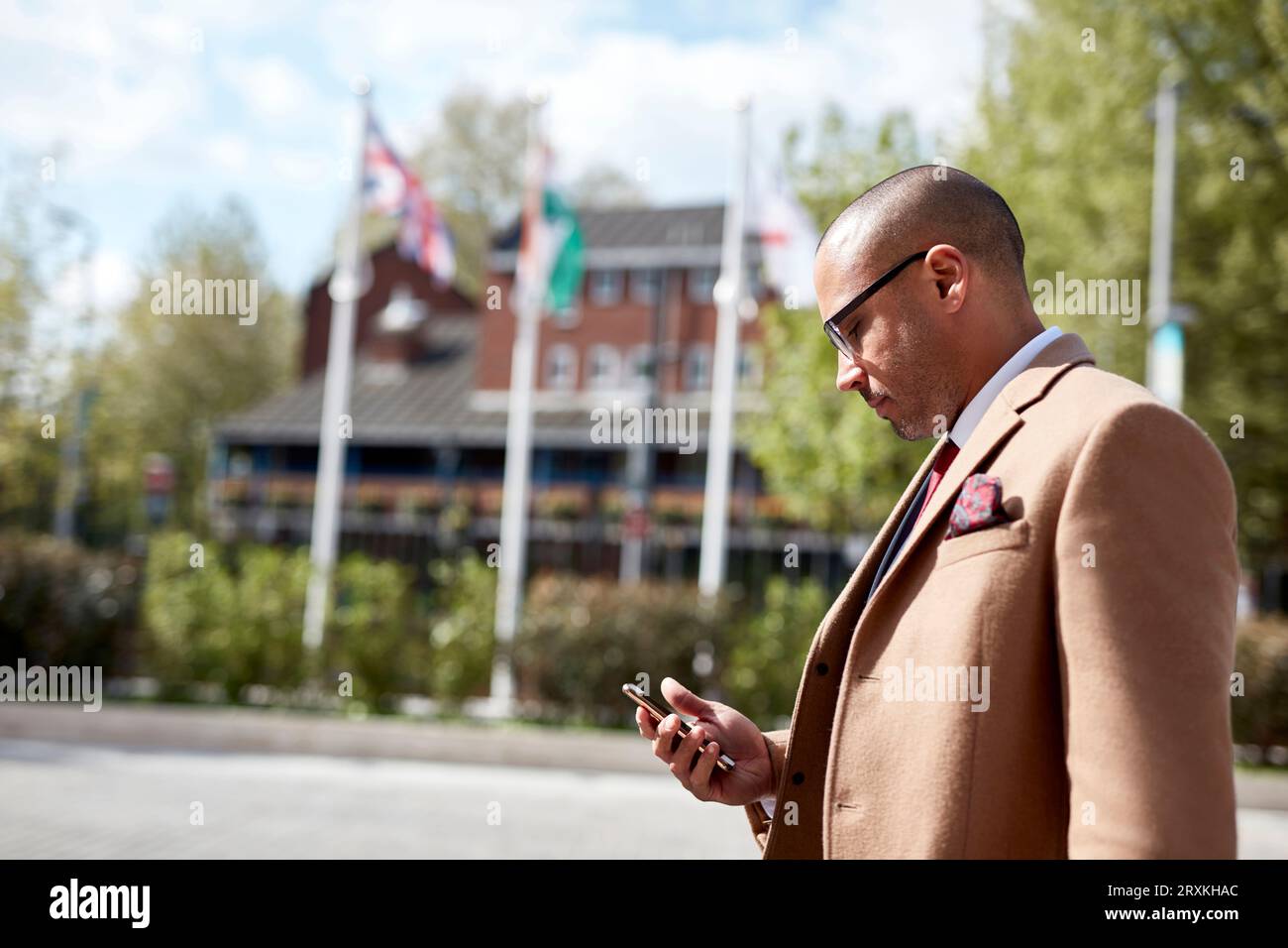Businessman text messaging on smart phone Stock Photo