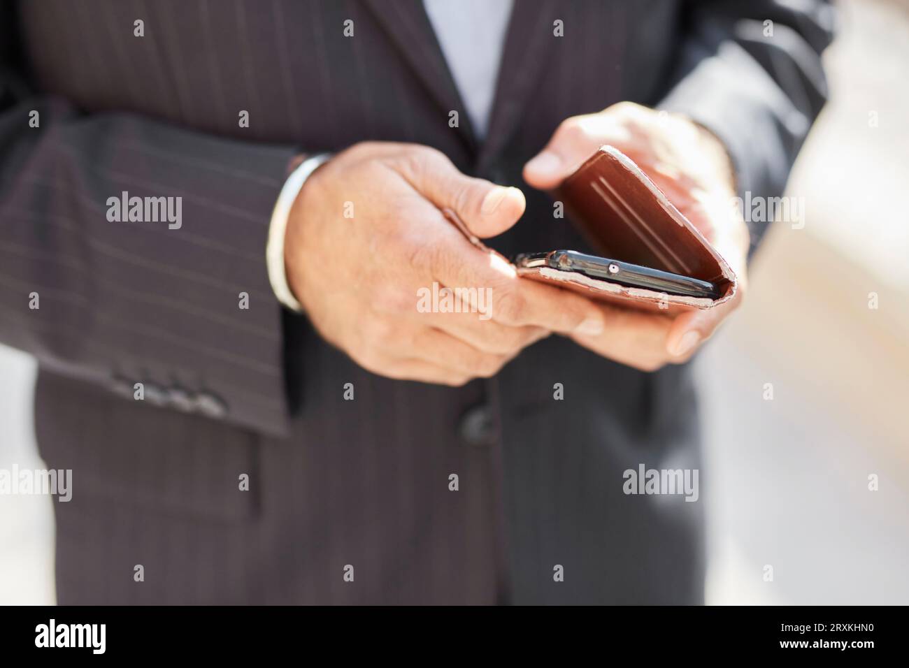 Hands of businessman using smartphone Stock Photo