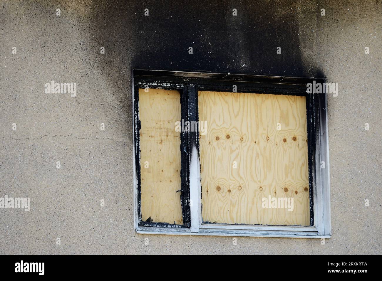 apartment window boarded up with plywood after a fire Stock Photo Alamy