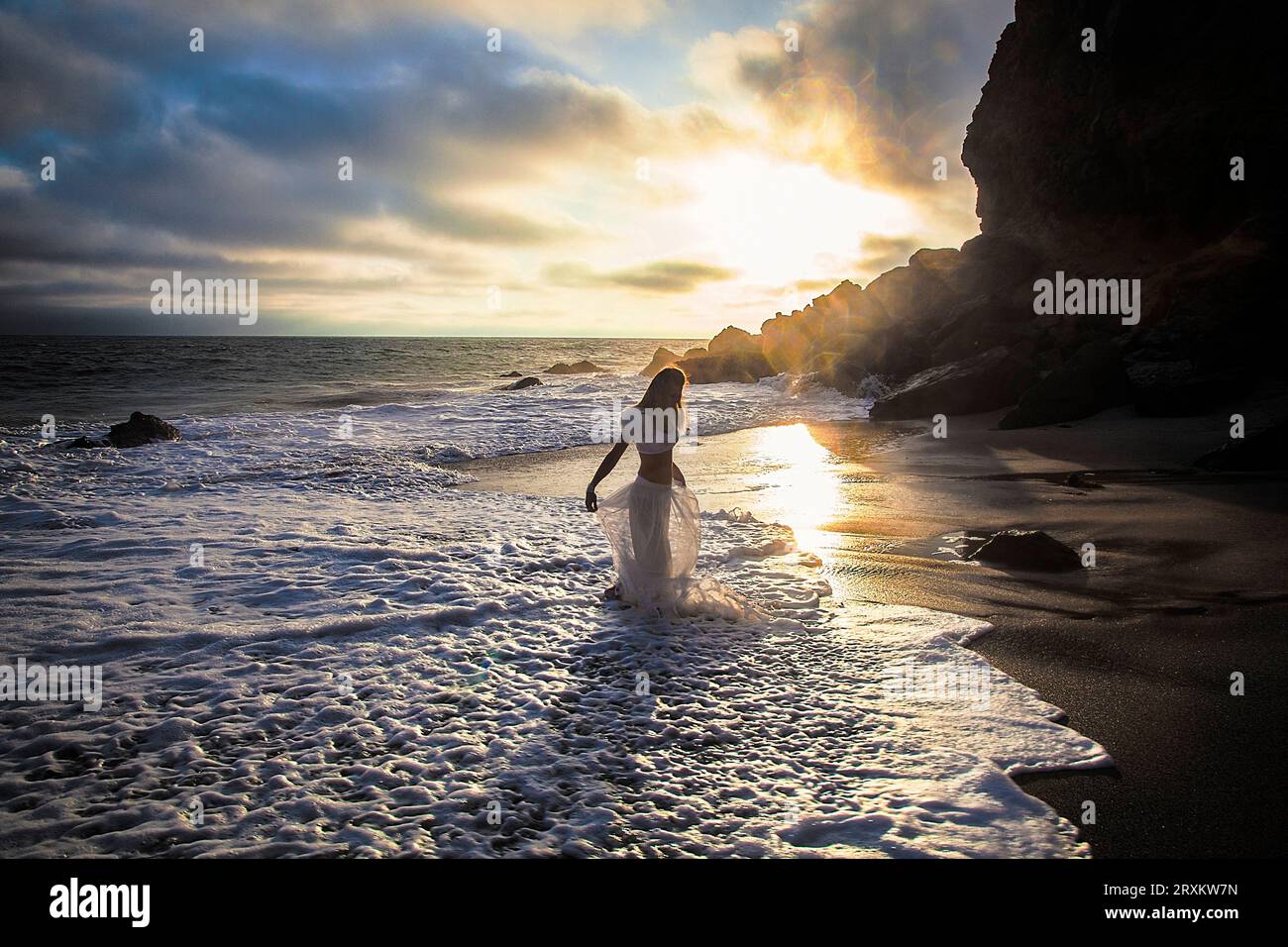 Woman in dress wading in water hi-res stock photography and images - Alamy