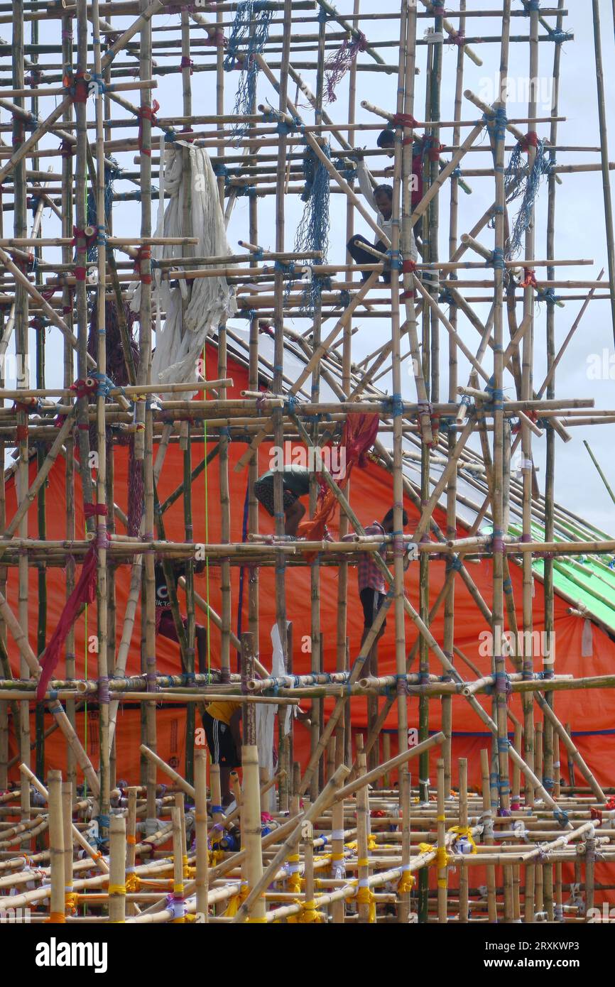 Workers are making a temporary bamboo structure, locally called 'Pandal', for the upcoming Durga Puja in Agartala. Tripura, India. Stock Photo