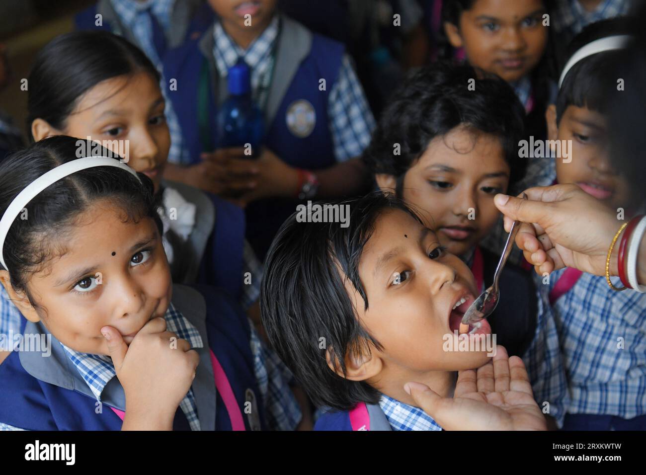 a-schoolteacher-is-giving-deworming-tablets-to-the-students-in-a-school