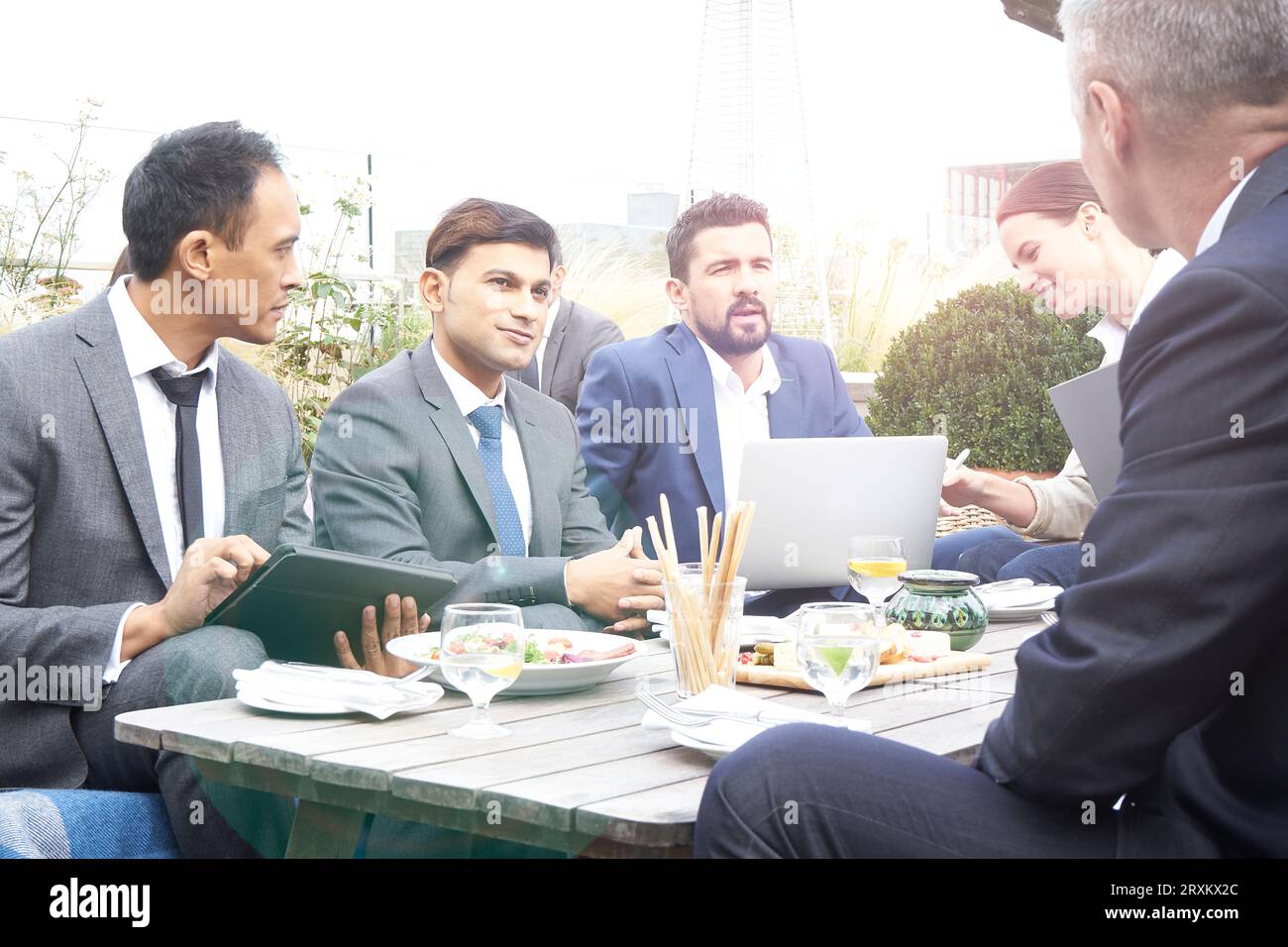 Businesspeople using laptop and tablet PC in restaurant Stock Photo