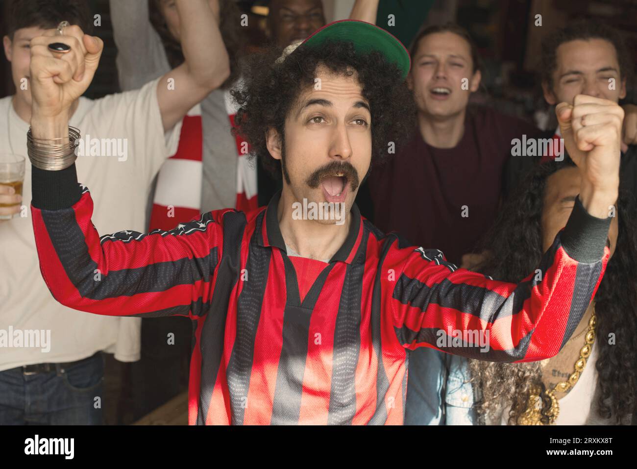 Excited fans cheering at a sports event. Stock Photo