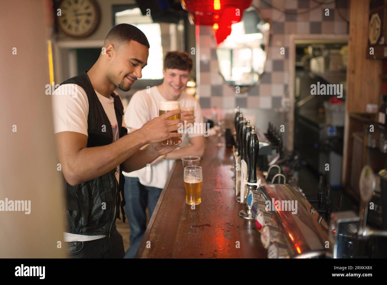 Friends enjoying beers at a bar Stock Photo