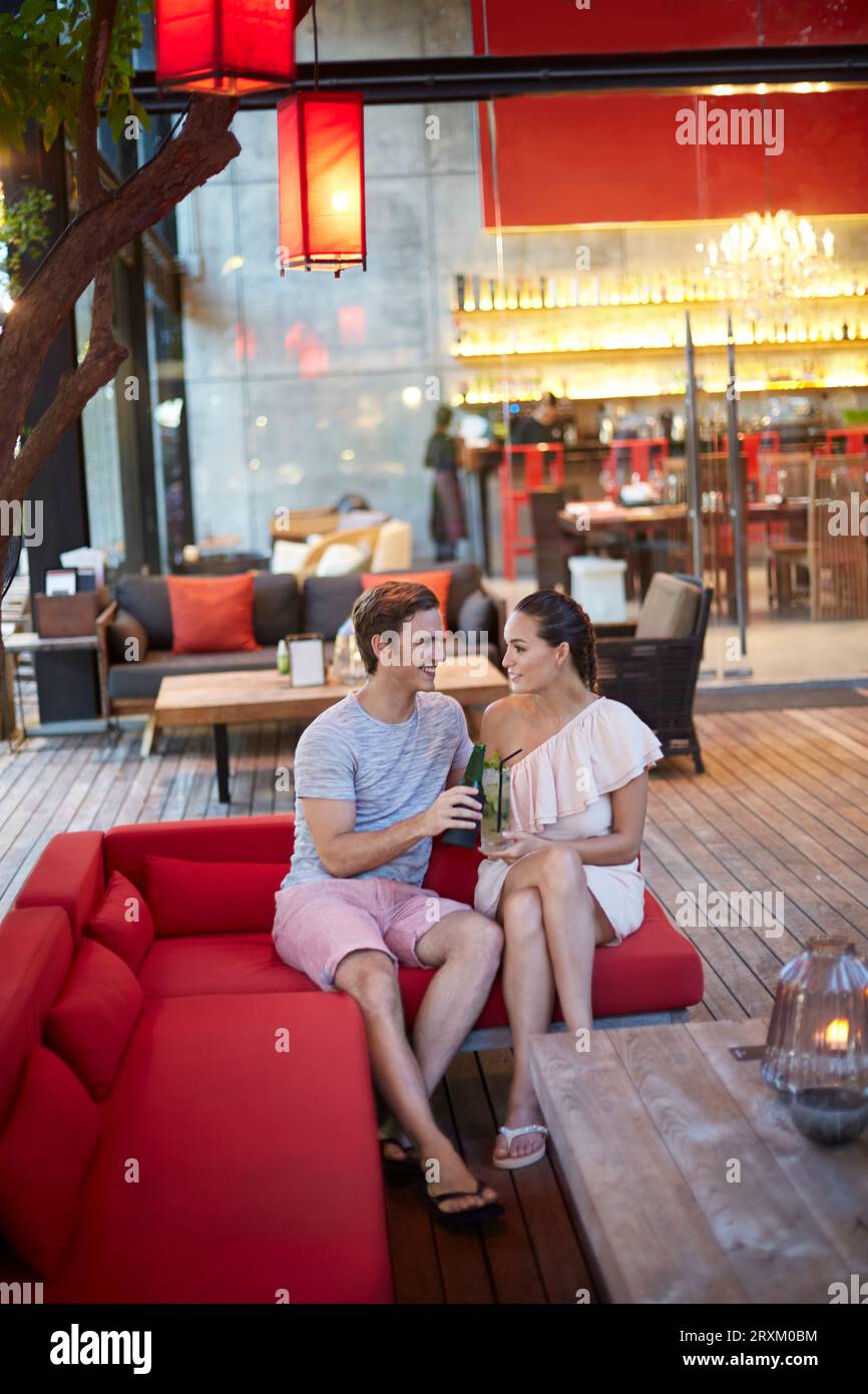Young couple toasting on sofa Stock Photo