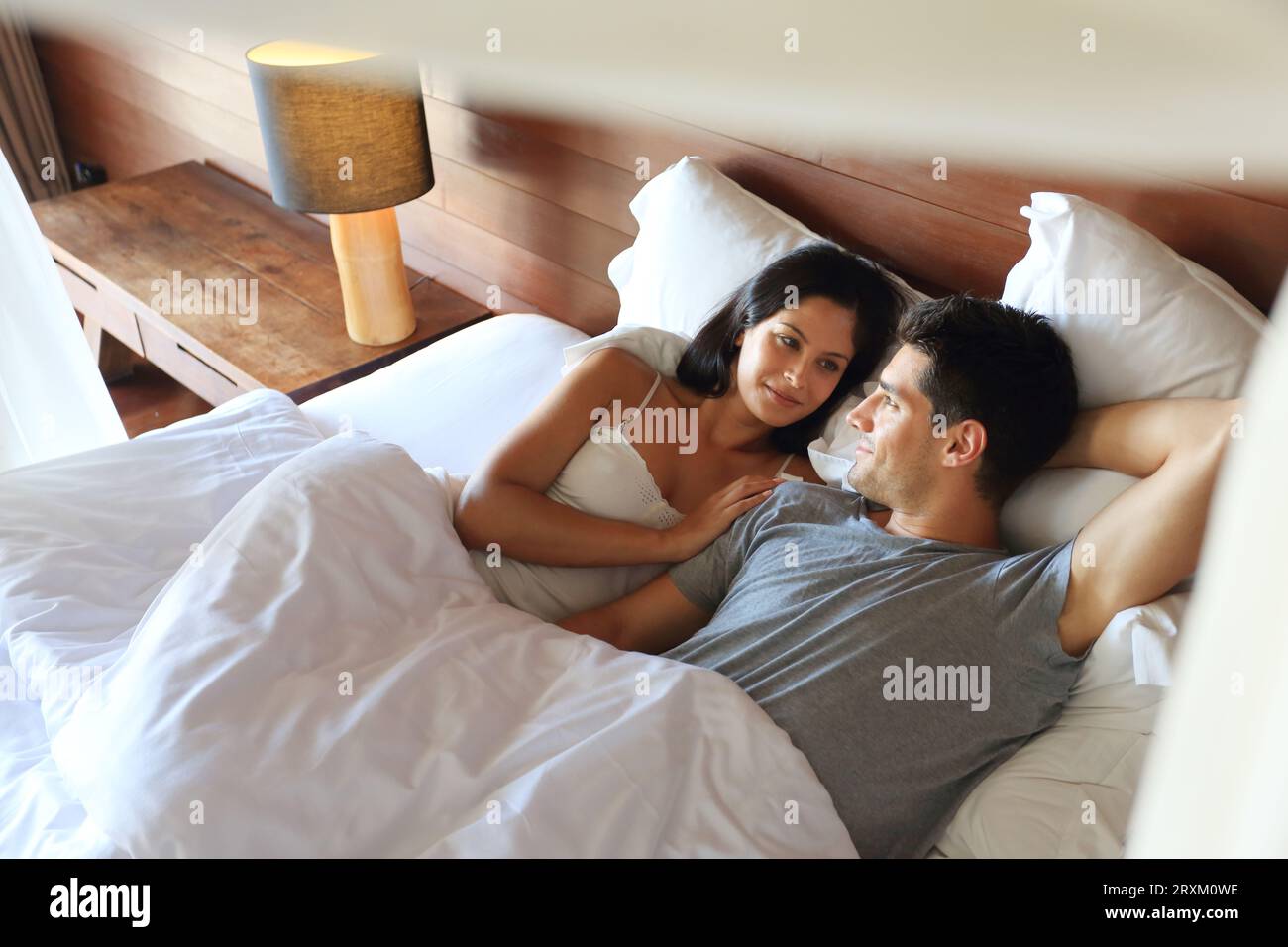 Young couple lying in bed Stock Photo