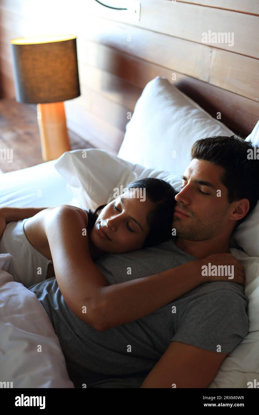 Young couple lying in bed Stock Photo