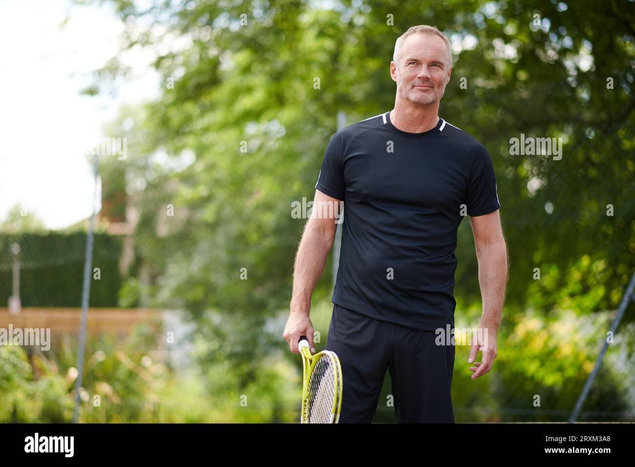 Mature man holding tennis racket Stock Photo