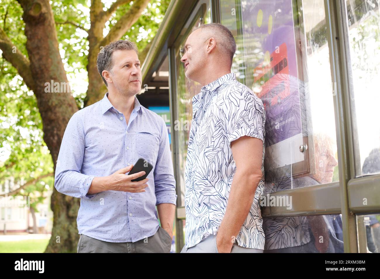 Mature couple by bus shelter Stock Photo