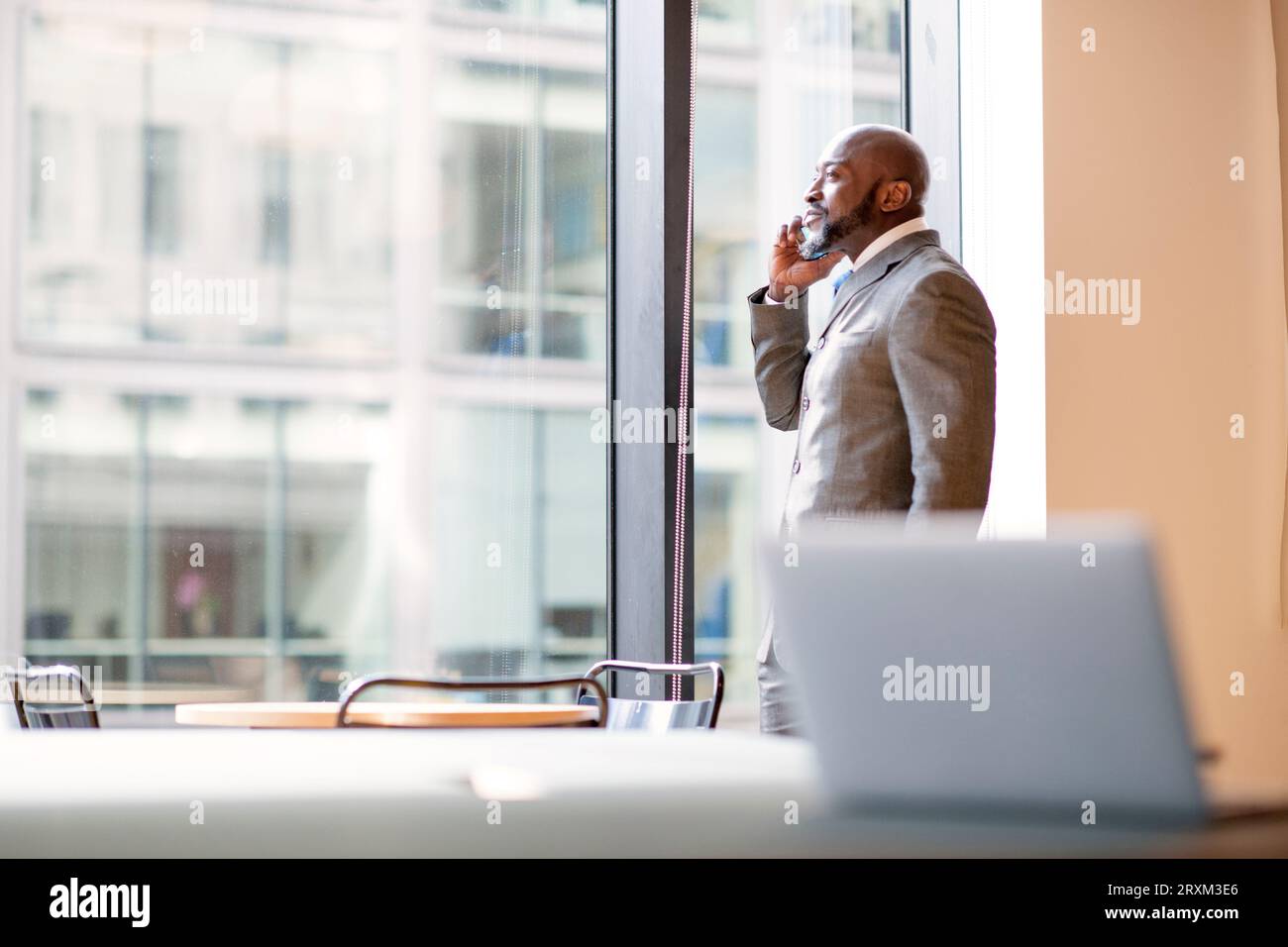 Businessman on phone in office Stock Photo