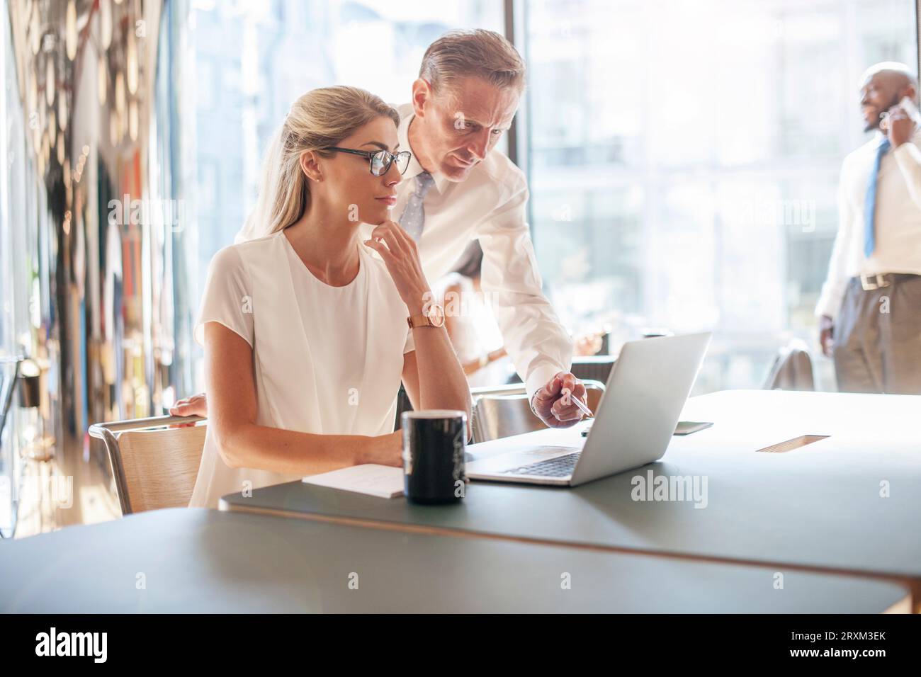 Colleagues using laptop Stock Photo