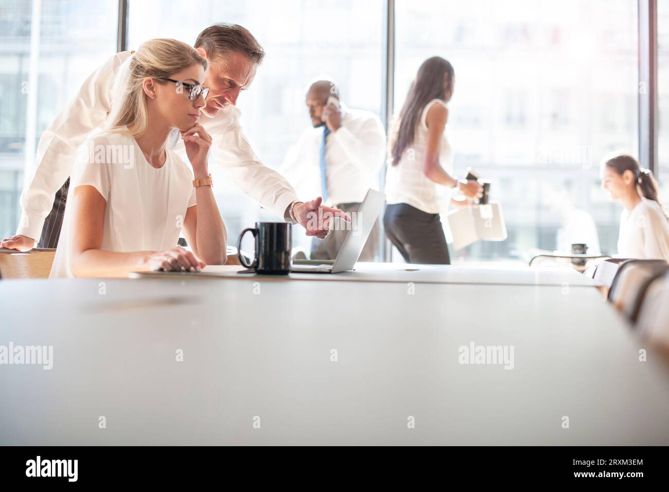 Colleagues using laptop Stock Photo