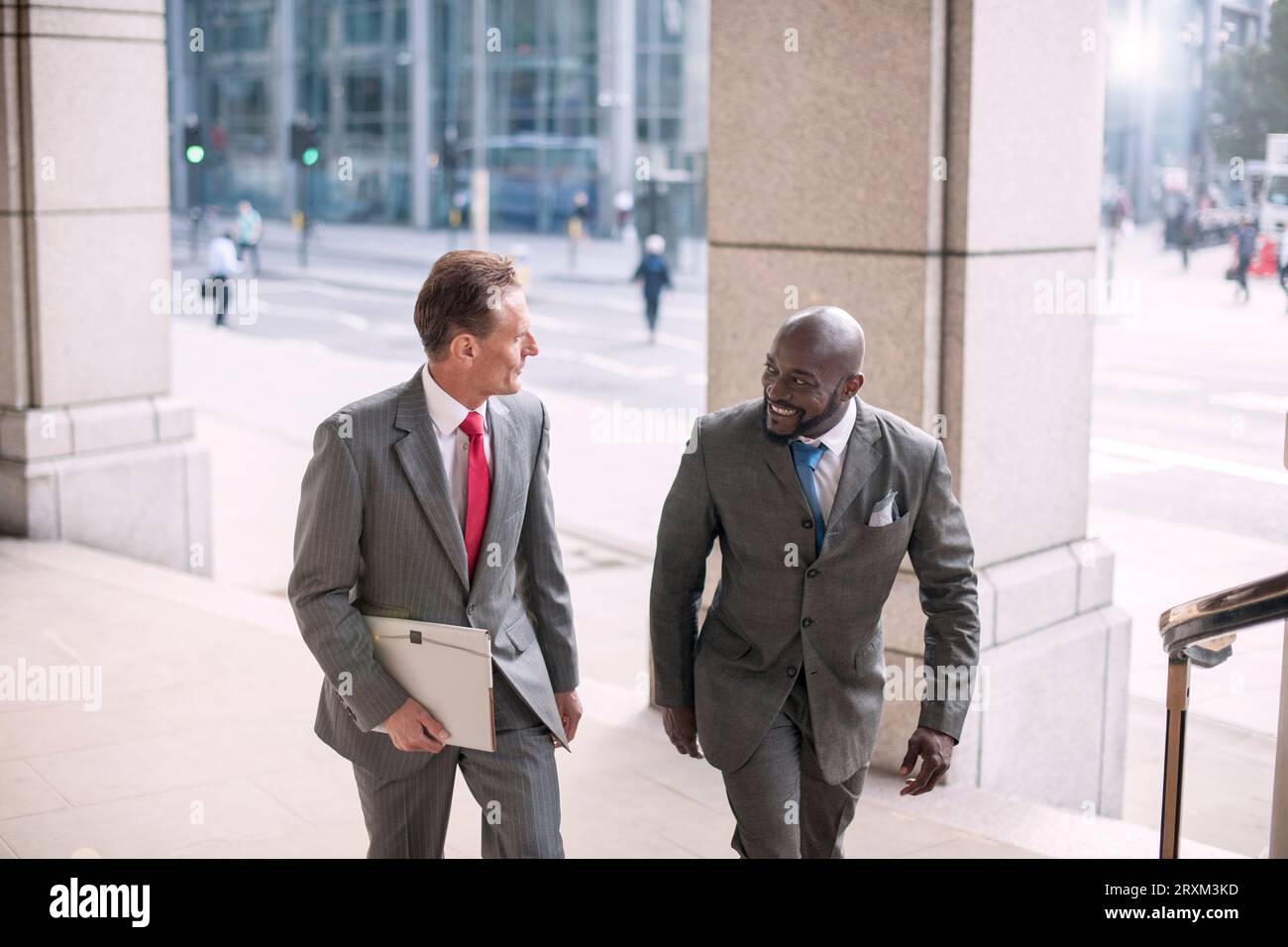 Businessmen wearing suits talking Stock Photo - Alamy