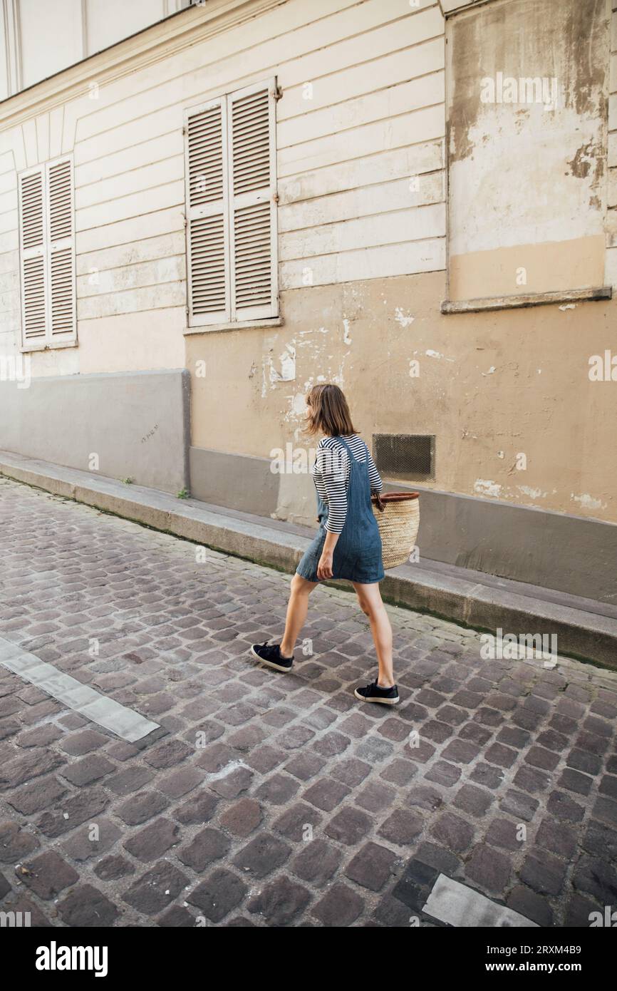 Young woman wearing denim dress on street Stock Photo