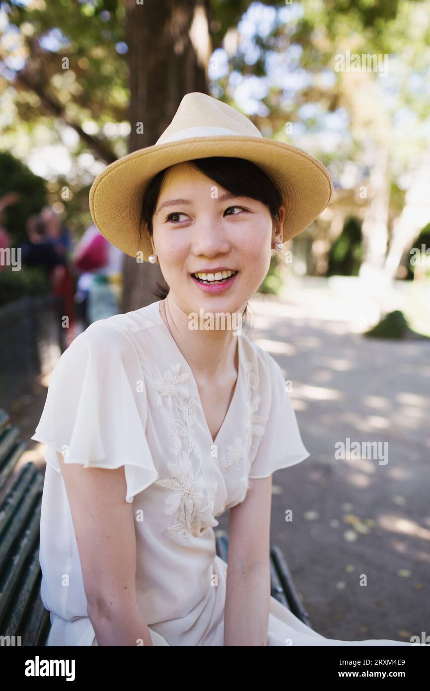 Smiling young woman wearing straw hat Stock Photo