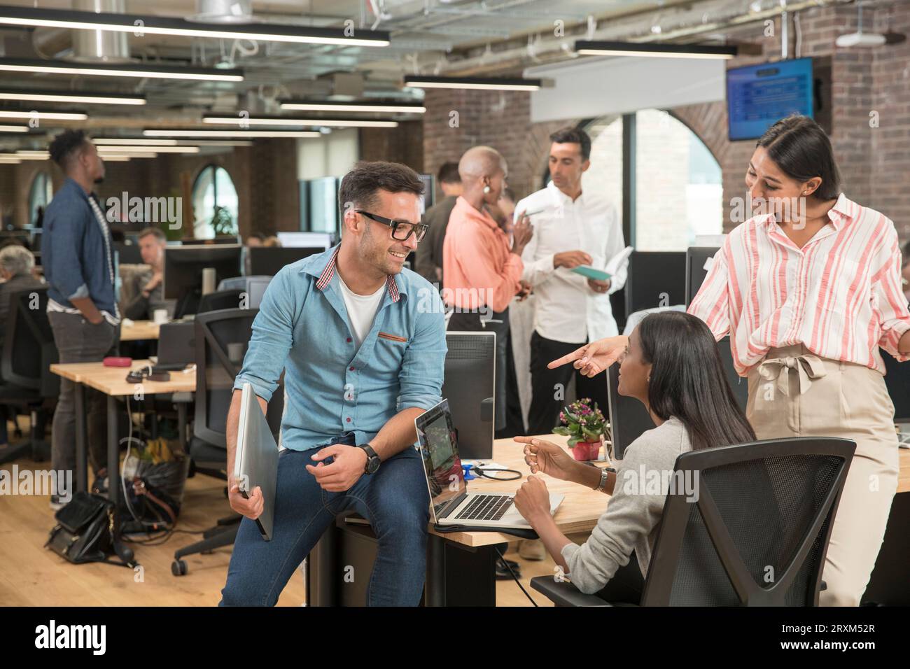 Colleagues talking in office Stock Photo