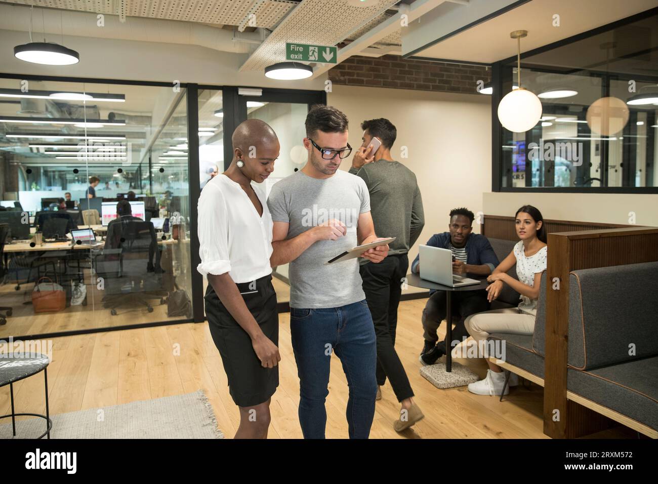 Colleagues using digital tablet in office Stock Photo