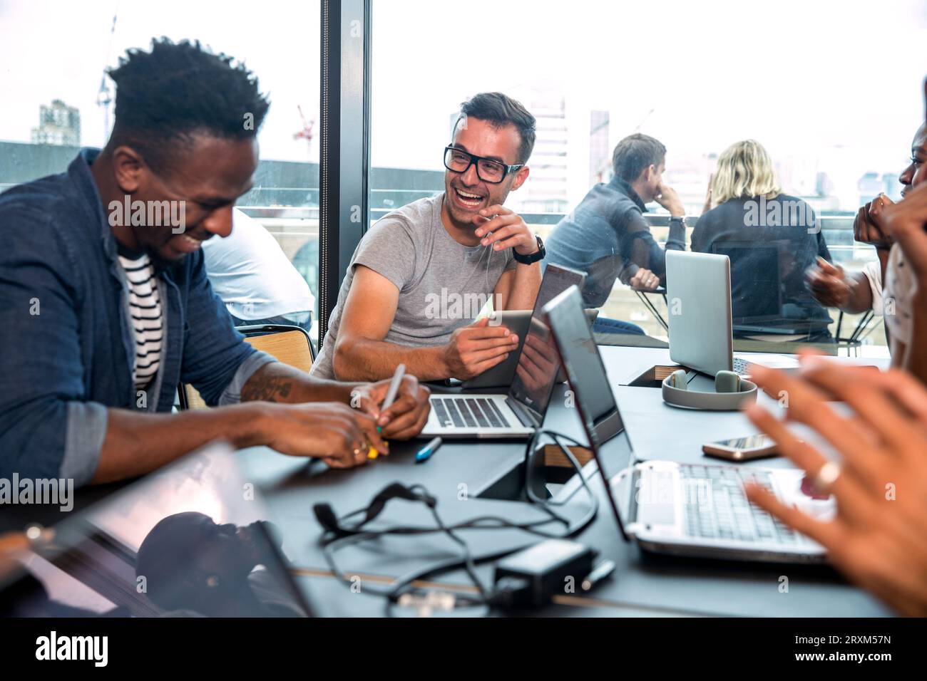 Colleagues using laptops during meeting Stock Photo